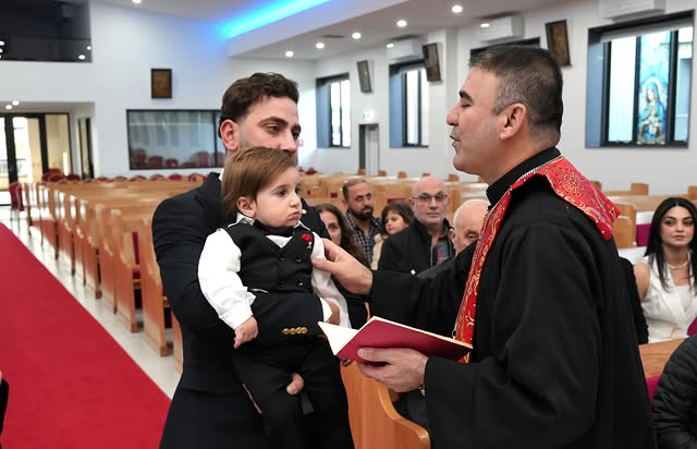 Father and child with the priest in church
