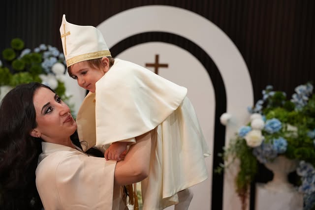 Mother holding her child at a christening